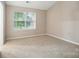 Bedroom with carpet, a large window, and a neutral color scheme at 110 Rhett Ct, Fort Mill, SC 29715