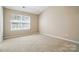 Bedroom with neutral carpet, walls, and a large window at 110 Rhett Ct, Fort Mill, SC 29715