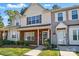 Two-story townhome showcasing a classic design with brick accents and well-kept landscaping at 110 Rhett Ct, Fort Mill, SC 29715