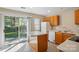 Well-lit kitchen with wooden cabinetry, an island, and a sliding glass door at 110 Rhett Ct, Fort Mill, SC 29715