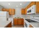 Traditional kitchen with wood cabinets, white appliances, and light countertops at 110 Rhett Ct, Fort Mill, SC 29715