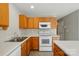 Functional kitchen with wooden cabinets, white appliances, and ample counter space at 110 Rhett Ct, Fort Mill, SC 29715