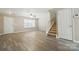 Inviting living area with new floors, a ceiling fan, and staircase access at 110 Rhett Ct, Fort Mill, SC 29715