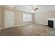 Bright living room with modern floors, ceiling fan, and a cozy fireplace at 110 Rhett Ct, Fort Mill, SC 29715