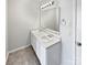 Bathroom featuring a double vanity, a bright mirror and modern lighting at 1121 Swearngan Ridge Ct, Charlotte, NC 28216