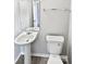 Bathroom with pedestal sink and toilet, featuring gray walls and tile flooring at 1121 Swearngan Ridge Ct, Charlotte, NC 28216
