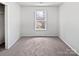 Comfortable bedroom with large window offering a scenic outdoor view at 1121 Swearngan Ridge Ct, Charlotte, NC 28216