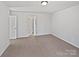 Serene bedroom with plush carpeting, a closet, and a connecting door at 1121 Swearngan Ridge Ct, Charlotte, NC 28216