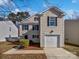 Charming home with a one-car garage and neutral siding under a bright, blue sky at 1121 Swearngan Ridge Ct, Charlotte, NC 28216