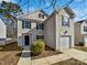 Two-story home with a one-car garage and neutral siding under a bright, blue sky at 1121 Swearngan Ridge Ct, Charlotte, NC 28216