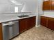 Well-equipped kitchen with stainless steel dishwasher, wood cabinets, and a double basin sink at 1121 Swearngan Ridge Ct, Charlotte, NC 28216