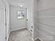 Functional laundry room with shelving and a window, providing natural light at 1121 Swearngan Ridge Ct, Charlotte, NC 28216