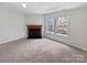 Spacious living room with a fireplace and natural light at 1121 Swearngan Ridge Ct, Charlotte, NC 28216