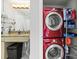 Convenient laundry area with stacked, red washer and dryer and storage at 1133 Metropolitan Ave # 318, Charlotte, NC 28204