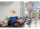 Bright living room with hardwood floors, high ceilings, modern furniture, and an outdoor balcony at 1133 Metropolitan Ave # 318, Charlotte, NC 28204