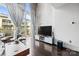 Contemporary living room with hardwood floors, floor-to-ceiling windows, and a large flatscreen television at 1133 Metropolitan Ave # 318, Charlotte, NC 28204