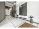 Modern lobby area with tiled floors, bench seating, plants and modern art at 1133 Metropolitan Ave # 318, Charlotte, NC 28204