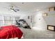 Spacious main bedroom featuring carpet floors, a ceiling fan, and a functional office space at 1133 Metropolitan Ave # 318, Charlotte, NC 28204