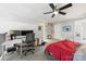 Spacious main bedroom featuring carpet floors, a ceiling fan, and a functional office space at 1133 Metropolitan Ave # 318, Charlotte, NC 28204