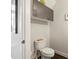 A quaint powder room featuring an upper cabinet for storage and a neutral color palette at 1133 Metropolitan Ave # 318, Charlotte, NC 28204