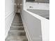 Well-lit staircase with carpeted steps and white walls at 1133 Metropolitan Ave # 318, Charlotte, NC 28204