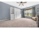 Open bedroom with lots of natural light, built in shelving, carpet and blue walls at 119 Charthouse Ln, Mooresville, NC 28117