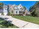 Beautiful two-story home with stone accents, shutters, and a well-manicured front lawn at 119 Charthouse Ln, Mooresville, NC 28117