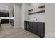 Stylish bar area features dark cabinetry, a marble countertop, a beverage fridge, and floating shelves at 123 Mills Garden Rd, Statesville, NC 28625