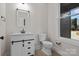 Charming bathroom features a modern vanity with black hardware and wood look flooring at 123 Mills Garden Rd, Statesville, NC 28625