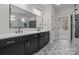 Bathroom featuring a double vanity with marble countertops, gold hardware and decorative floors at 123 Mills Garden Rd, Statesville, NC 28625