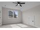 Bright, carpeted bedroom with a large window and a unique dormer door adding character to the space at 123 Mills Garden Rd, Statesville, NC 28625