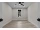 Neutral bedroom with wood look flooring, a ceiling fan and large window at 123 Mills Garden Rd, Statesville, NC 28625