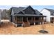 Stunning two-story home with a covered porch, wood columns, and ample natural light at 123 Mills Garden Rd, Statesville, NC 28625