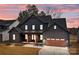 Charming two-story home featuring a modern design, a covered porch, and an attached two-car garage at 123 Mills Garden Rd, Statesville, NC 28625