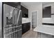 Modern kitchen featuring stainless steel refrigerator, dark cabinets, white countertops, and a walk-in pantry at 123 Mills Garden Rd, Statesville, NC 28625