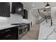 Gourmet kitchen boasts stainless steel appliances, dark cabinetry, white countertops, and a modern range hood at 123 Mills Garden Rd, Statesville, NC 28625