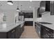 Spacious kitchen features dark cabinetry, stainless steel appliances, marble countertops, and modern pendant lighting at 123 Mills Garden Rd, Statesville, NC 28625
