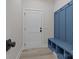 Bright mudroom with blue built-in bench and cubbies, offering a stylish and functional entryway storage solution at 123 Mills Garden Rd, Statesville, NC 28625