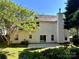 Backyard with mature trees and bushes and concrete patio at 12403 Panthersville Dr, Charlotte, NC 28269