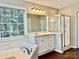 Bathroom featuring soaking tub, vanity with granite counters, and separate shower at 12403 Panthersville Dr, Charlotte, NC 28269