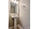 Bathroom featuring pedestal sink, decorative mirror, and modern fixtures at 12403 Panthersville Dr, Charlotte, NC 28269