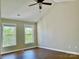 Light filled upstairs bedroom with two windows and wood flooring at 12403 Panthersville Dr, Charlotte, NC 28269
