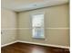 Bright bedroom with fresh paint, wood flooring, and modern window casing at 12403 Panthersville Dr, Charlotte, NC 28269