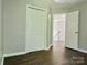 A view of bedroom with closet and doorway leading to stairwell at 12403 Panthersville Dr, Charlotte, NC 28269