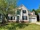 Traditional two-story home with a two-car garage, complemented by a well-manicured front lawn at 12403 Panthersville Dr, Charlotte, NC 28269