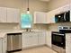 Bright kitchen offering modern appliances, white cabinetry, and stainless steel dishwasher at 12403 Panthersville Dr, Charlotte, NC 28269