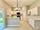 Bright kitchen with white cabinets, stainless steel appliances and backyard access at 12403 Panthersville Dr, Charlotte, NC 28269