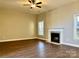 Spacious living room with hardwood floors, fireplace, and ceiling fan at 12403 Panthersville Dr, Charlotte, NC 28269