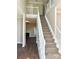 Spacious entryway with staircase and hardwood floors, leading to a cozy living room with a fireplace at 12403 Panthersville Dr, Charlotte, NC 28269