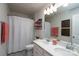 Clean bathroom with a double sink vanity, white cabinets, and a shower with a white curtain at 126 W Morehouse Ave, Mooresville, NC 28117